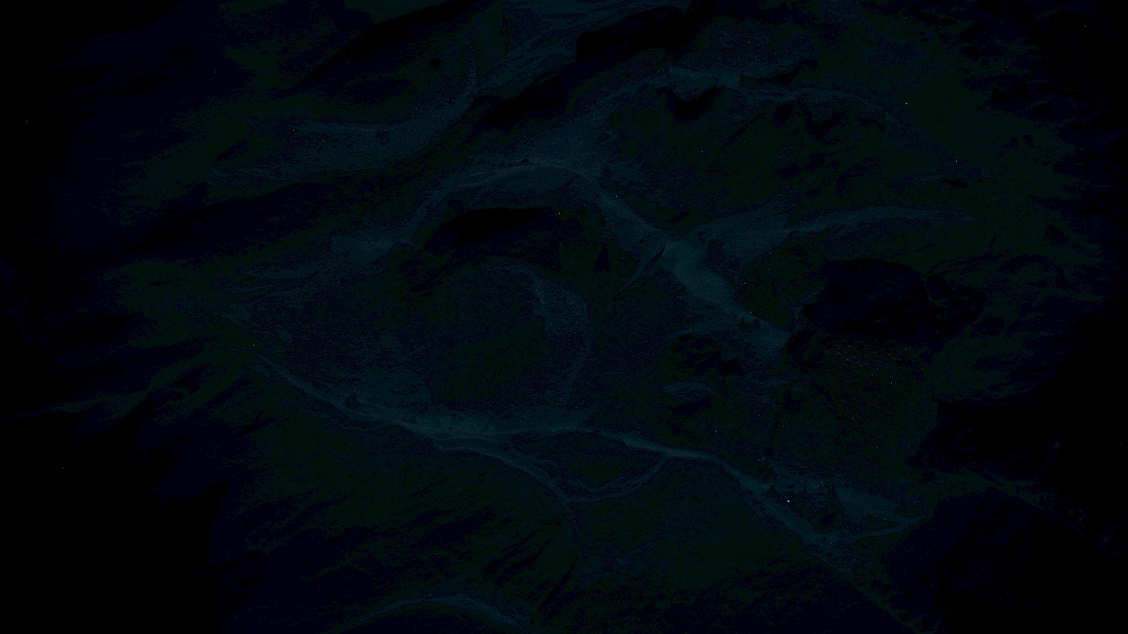 The image appears to show a dark, textured landscape with river-like formations and varied terrain.